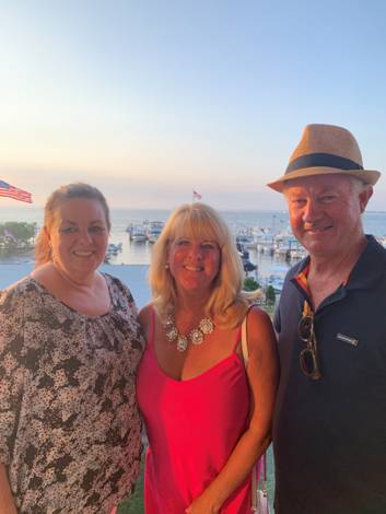 A group of people posing for a photo
Description automatically generated with medium confidence