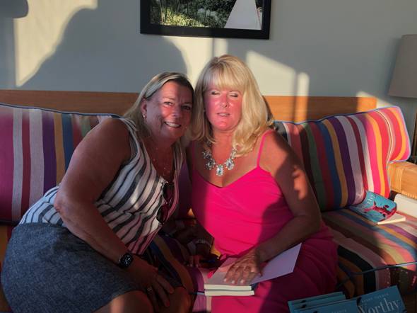 Two women sitting on a couch
Description automatically generated with medium confidence