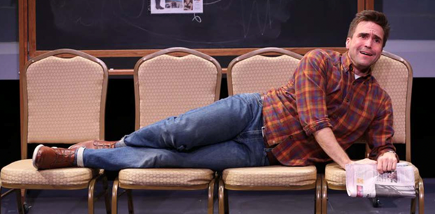 A person lying on chairs
Description automatically generated