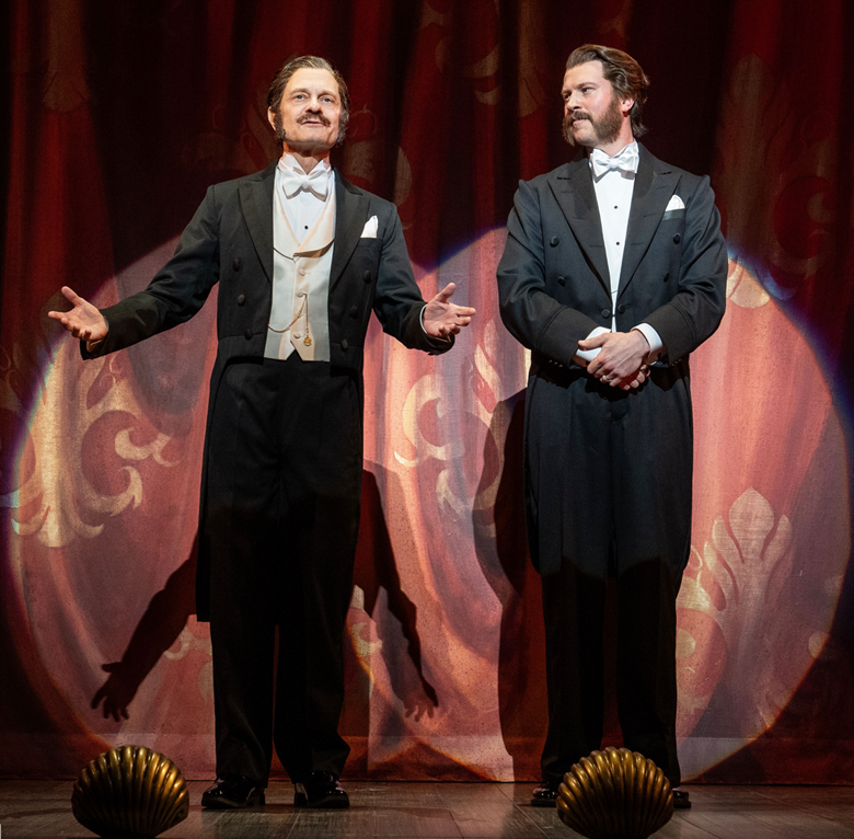Two men in tuxedos on a stage
Description automatically generated