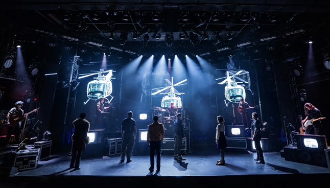 A group of people on a stage
Description automatically generated