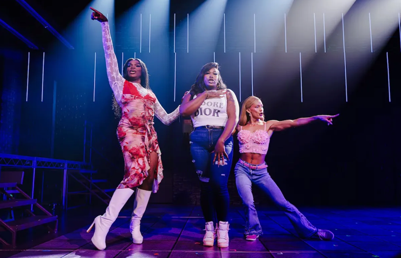 A group of women dancing on a stage
Description automatically generated