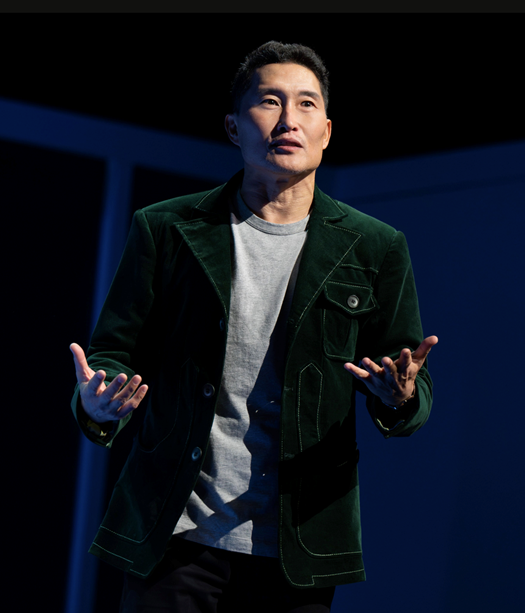 A person in a green jacket
Description automatically generated